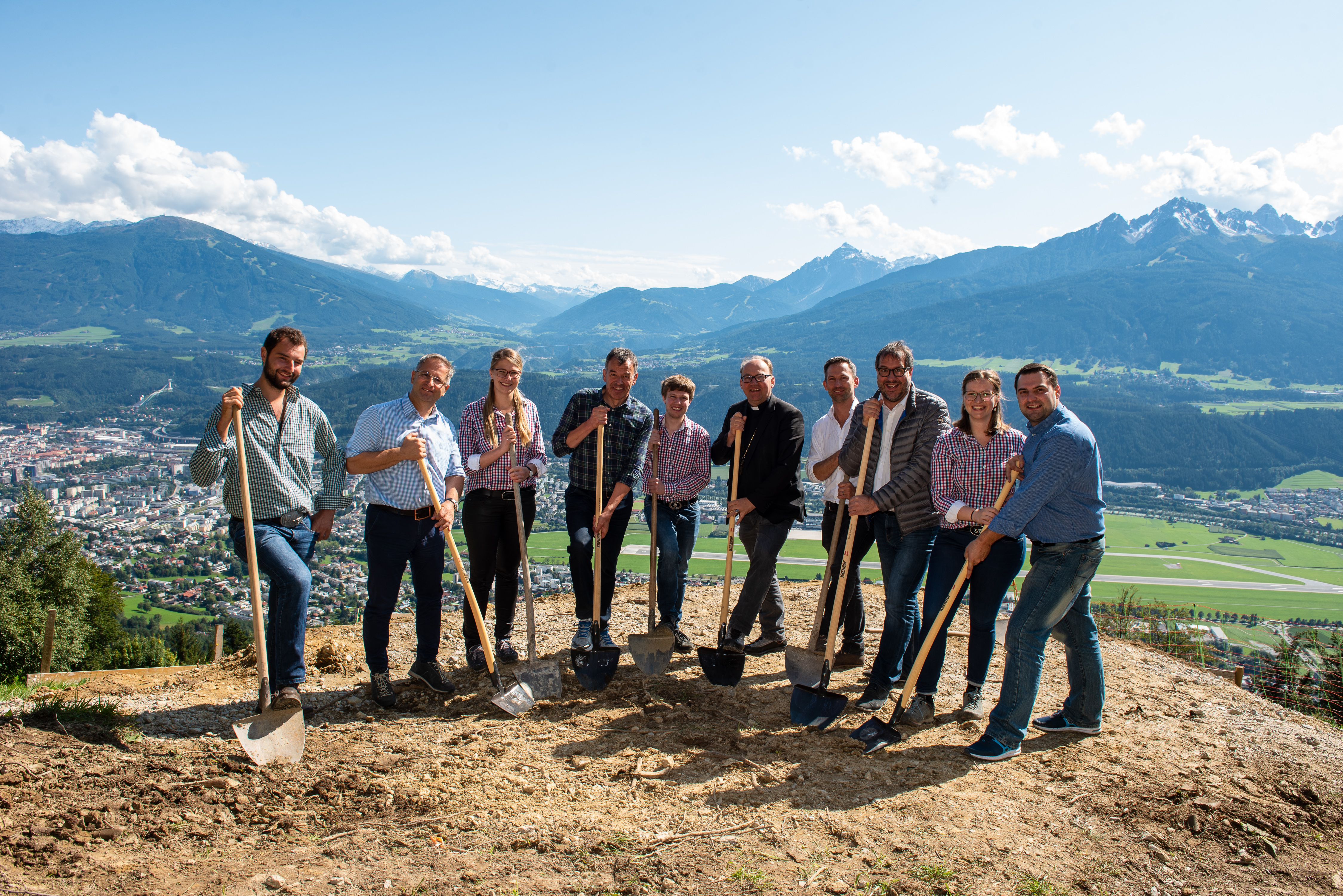 Die Bezirksgruppe der Jungbauernschaft Innsbruck lud zum Spatenstich der geplanten Herz-Jesu-Kapelle am Rauschbrunnen. Neben Bischof Hermann Glettler, zeigten auch Bürgermeister Georg Willi und Vizebürgermeister Franz X. Gruber ihre Unterstützung für das Projekt. Architekt DI Walter Klasz erklärte das auch aus Sicht der Architektur anspruchsvolle Bauvorhaben. Ein Projekt, das nur dank der aktiven Mitarbeit der Jungbauern und -bäurinnen verwirklicht werden wird. Ein Projekt in dem auch viel Herzblut steckt, soll die Kapelle doch einmal auch an die Verstorbenen der Bezirksjungbauernschaft erinnern, als ein Ort des gemeinsamen Gedenkens, des sich Besinnens und des Zusammenseins.